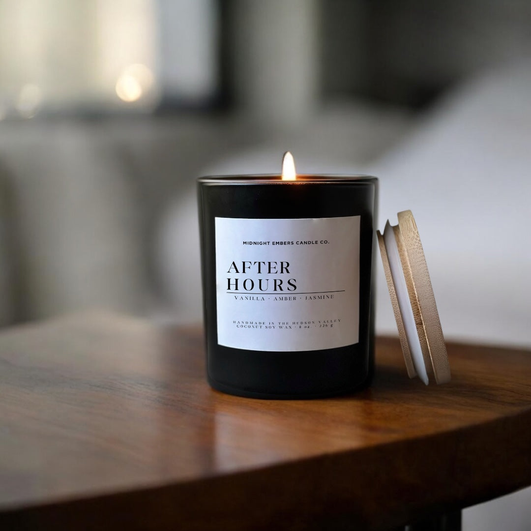Candle labeled 'After Hours' on a wooden surface with a blurred background
