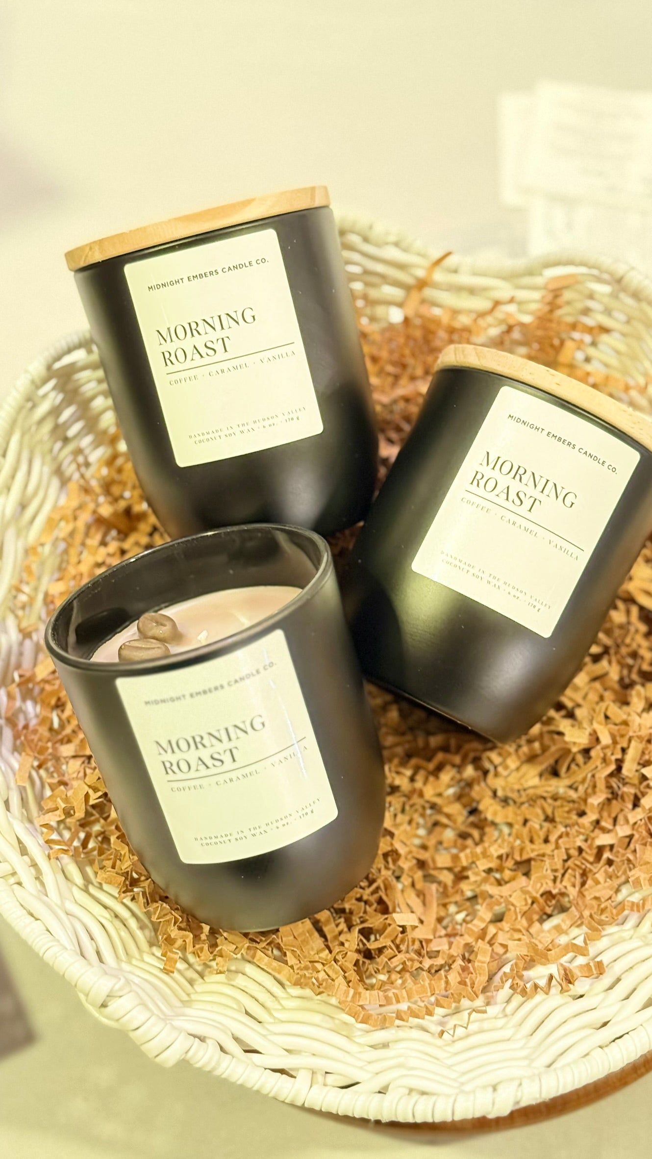 Three 'Morning Roast' candles in black containers on a textured surface